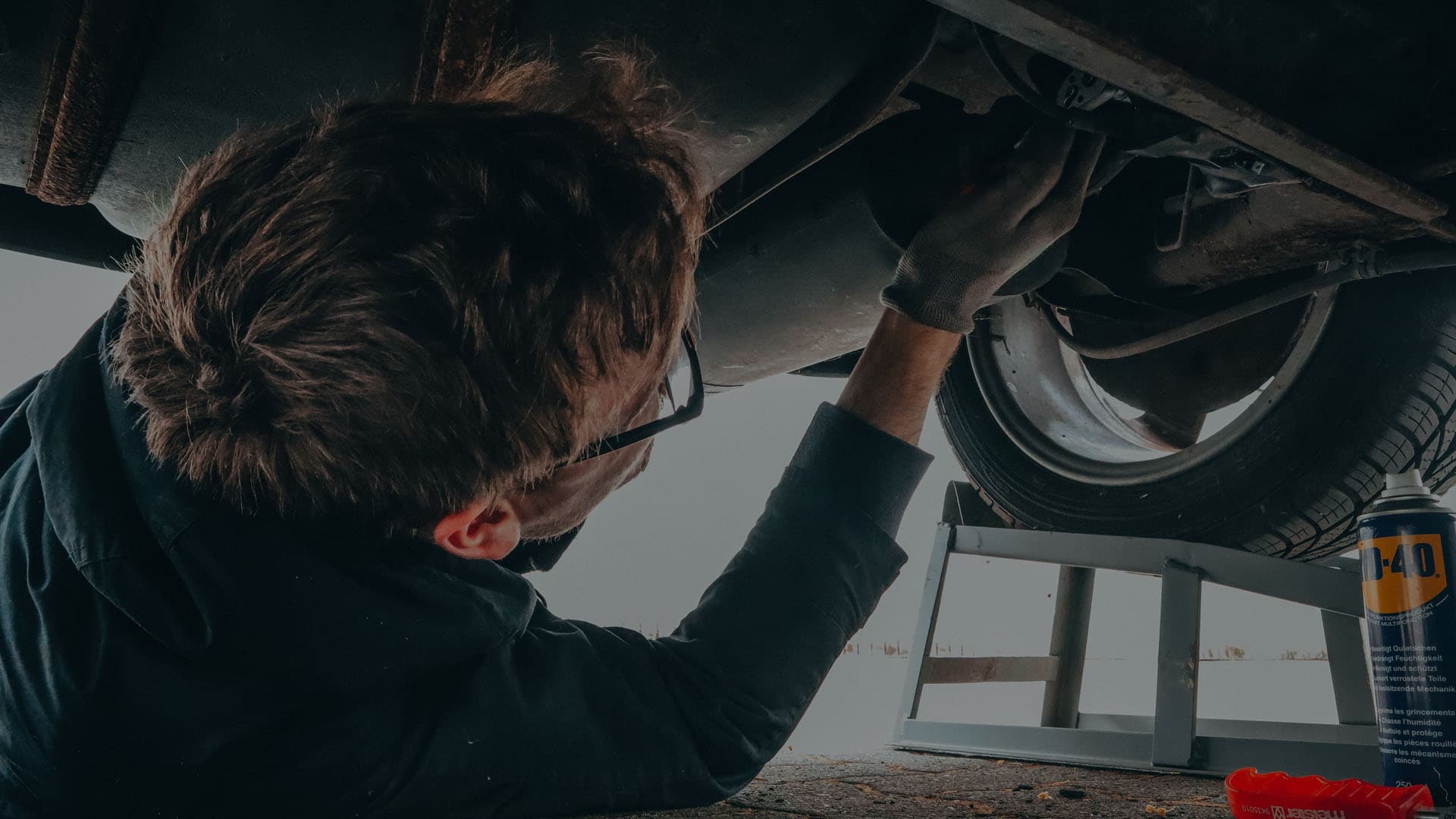 A mechanic working under the bonnet of a car at Baskal's Garage in Għajnsielem, Gozo